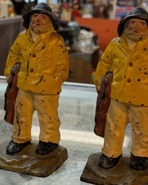 A pair of yellow-slicker fisherman figures on the Warren Exchange counter.