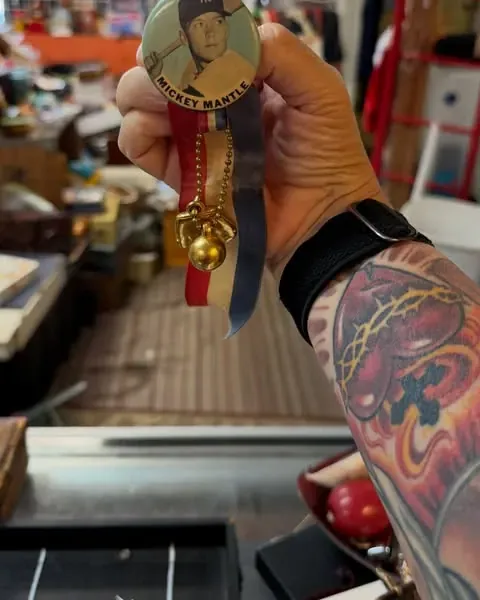 A vintage Mickey Mantle pin held up at the Warren Exchange counter.