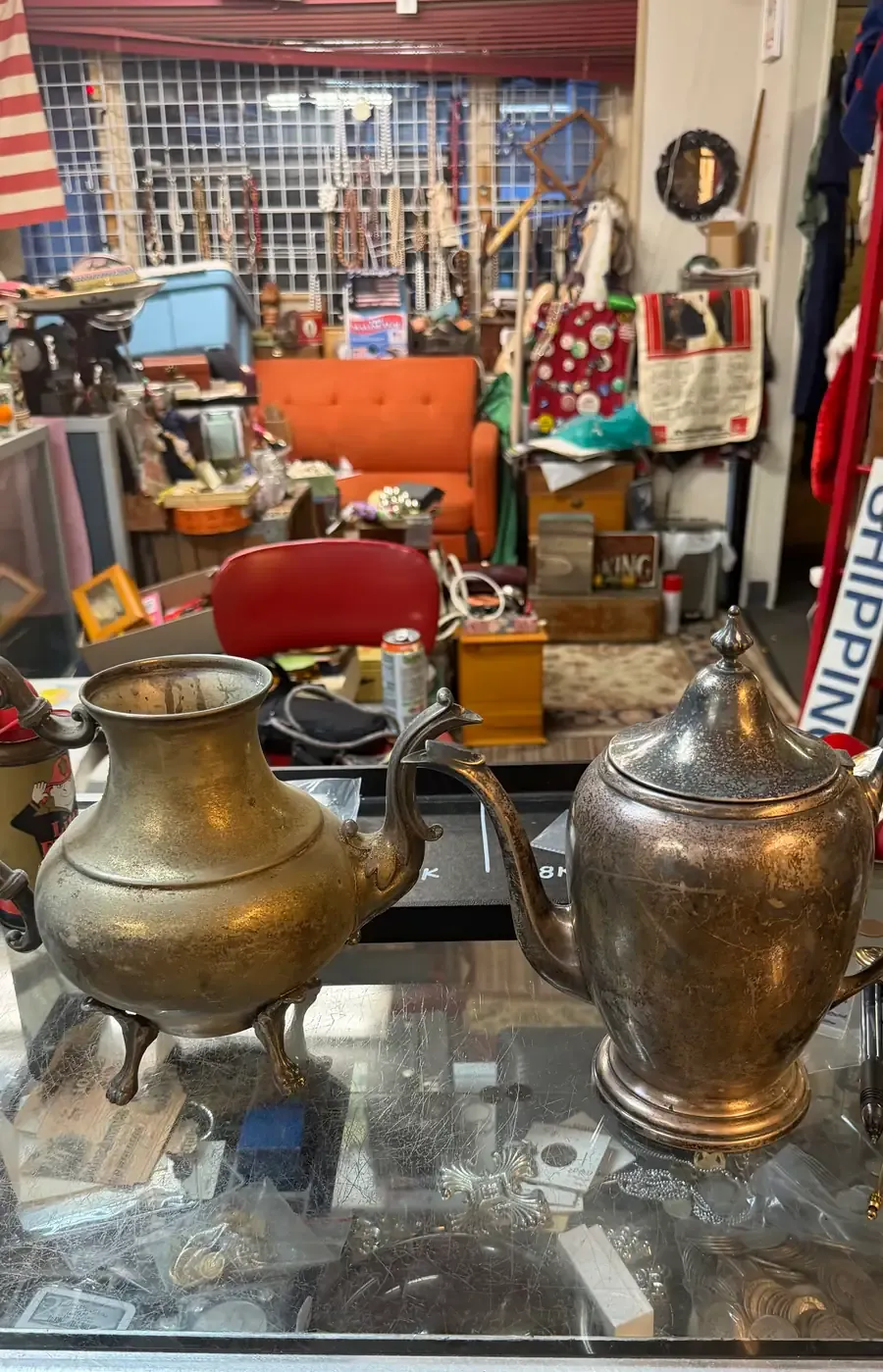 Sterling and silver-plated teapots with dramatically different values, side by side on the Warren Exchange counter.