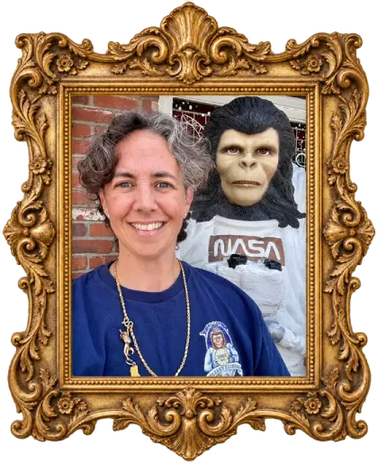 Tara, founder of Warren Exchange, smiling beside Zippy the space monkey.