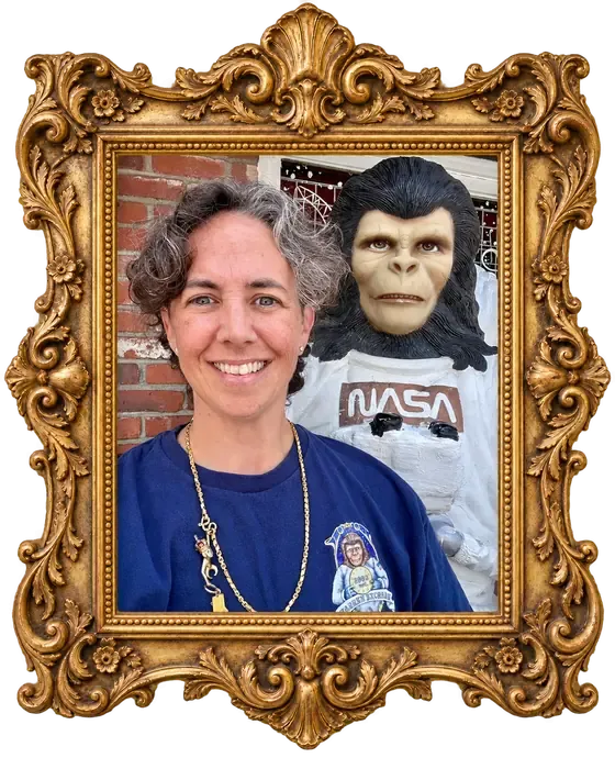 Tara, founder of Warren Exchange, smiling beside Zippy the space monkey.