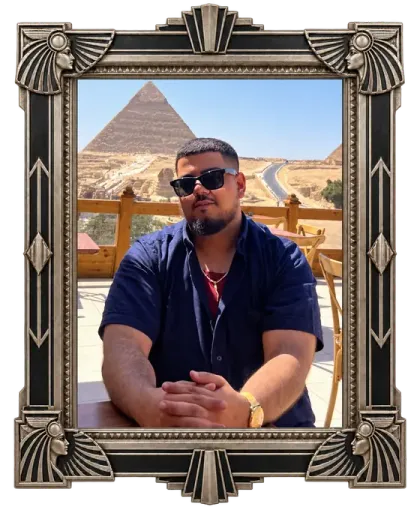 Zaza, Warren Exchange Whatnot host, seated with the pyramids behind him.