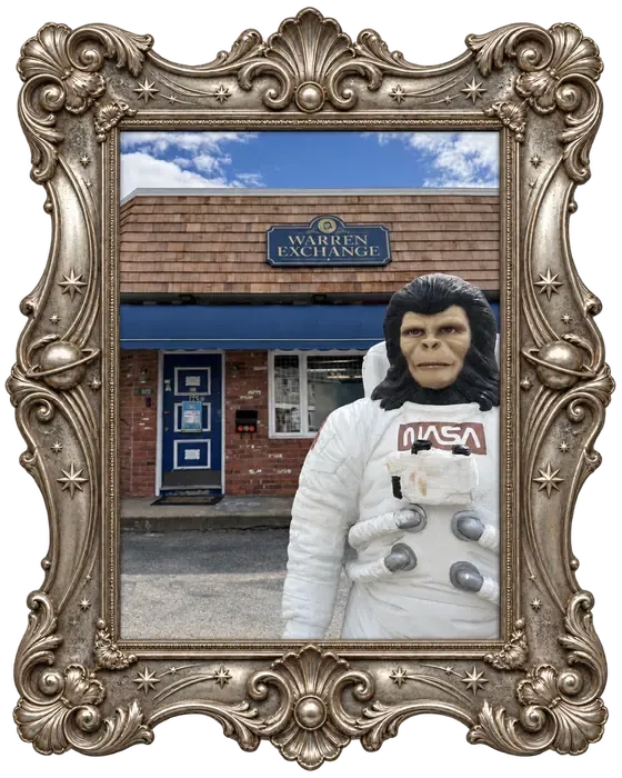 Zippy, Warren Exchange's space-monkey mascot, standing by the front door.